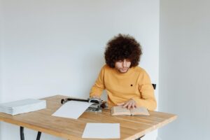 Curly Haired Man Sitting Reading a Book